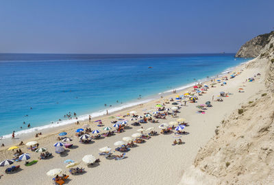 View of people at beach against clear sky