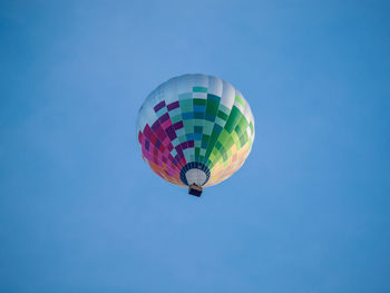 Low angle view of hot air balloon against blue sky