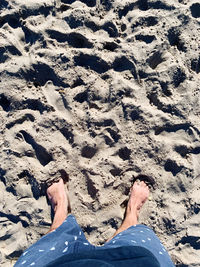 Low section of person legs on sand