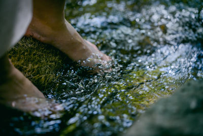 Close-up of person hand in water