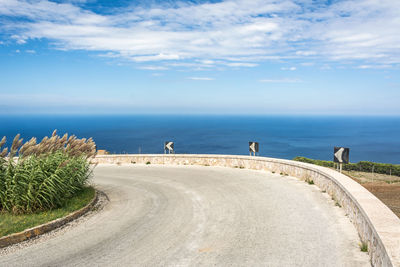 Road by sea against sky