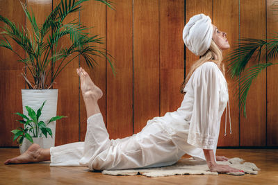 Woman practicing kundalini yoga, kriya exercises for the navel center and bowel waste elimination