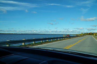 Road by sea against sky