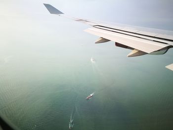 High angle view of airplane flying over sea