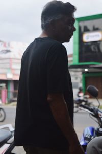 Rear view of man standing at bus