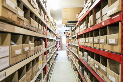 Stack of cardboard boxes on rack at distribution warehouse