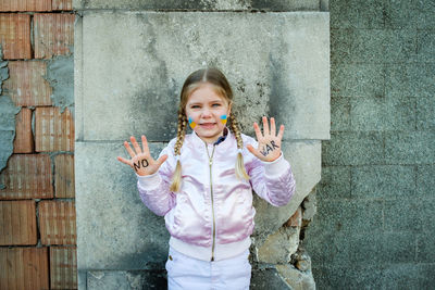 Portrait of girl with text on hands