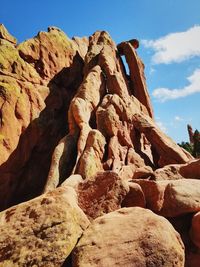 Low angle view of rock formation against sky