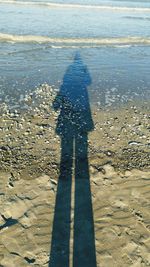 Shadow of woman on beach