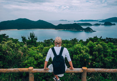 Portrait of man standing on mountain against sky