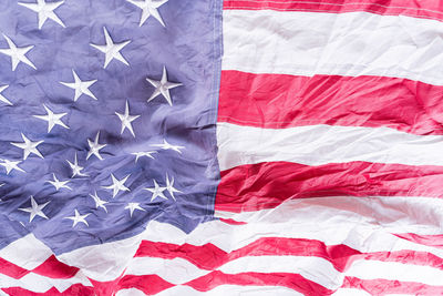 Close-up of flag against blue wall