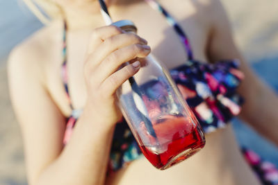 Girl having drink on beach