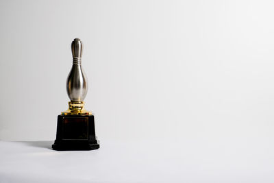 Close-up of bottle on table against white background