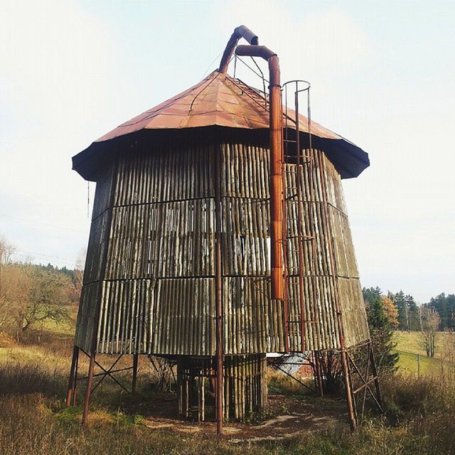 built structure, architecture, building exterior, sky, barn, clear sky, house, grass, field, wood - material, fence, day, rural scene, protection, outdoors, no people, safety, exterior, sunlight, security