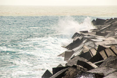 Scenic view of sea waves splashing on rocks