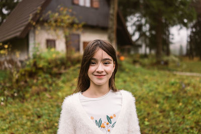 Portrait of smiling girl standing at park