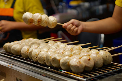 Cropped hand of person preparing food