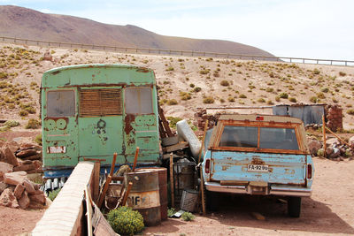 Abandoned truck on field against sky