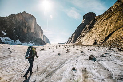 Rear view of mountaineer exploring glaciers and mounatins. on the move