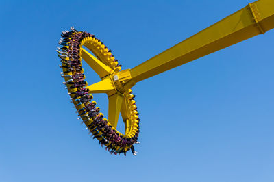 Low angle view of amusement park ride against clear sky