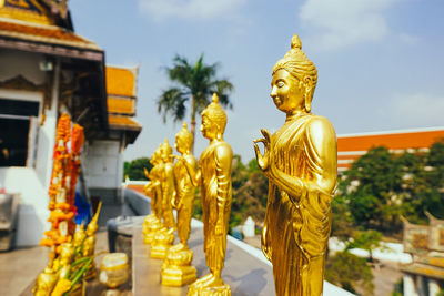 Statue outside temple against building