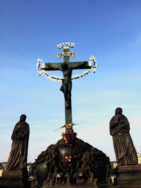 Low angle view of statue against temple against sky