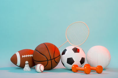 Low angle view of soccer ball on table against blue background