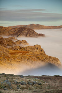 Scenic view of rocks on landscape against sky