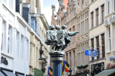 Low angle view of statue in front of building