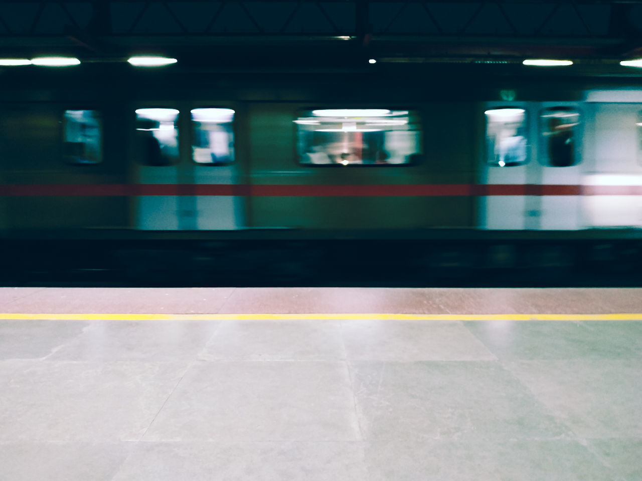 TRAIN ON RAILROAD STATION PLATFORM