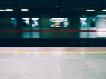 Blurred motion of train at railroad station platform