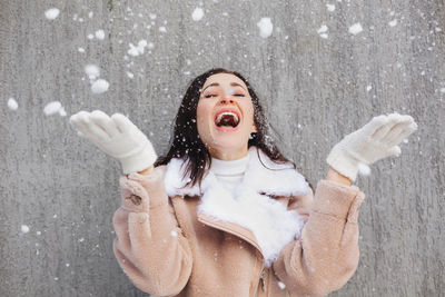 Full length of a smiling woman in snow