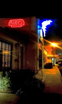 Illuminated text on building at night