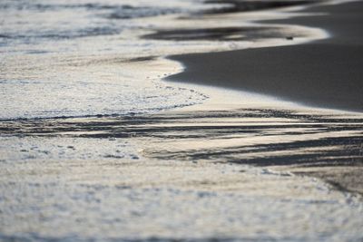 High angle view of tire tracks on beach