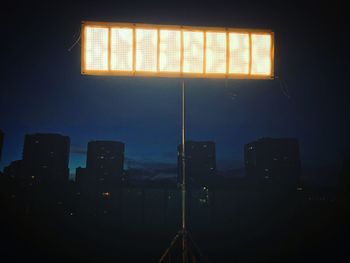 Illuminated cityscape against sky seen through window