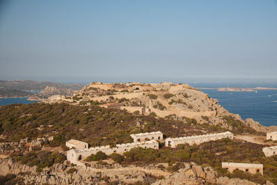 Scenic view of sea and mountains against sky