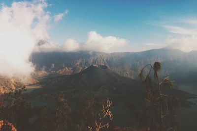 Scenic view of mountains against cloudy sky