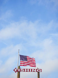 Low angle view of american flag against sky