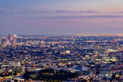 High angle view of illuminated buildings against sky at dusk