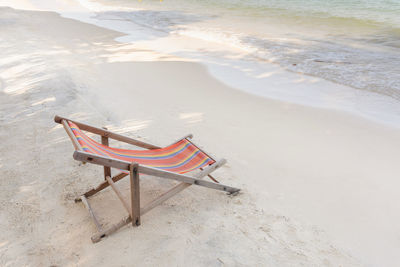 High angle view of chair on shore at beach