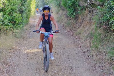 Full length of man riding bicycle on street