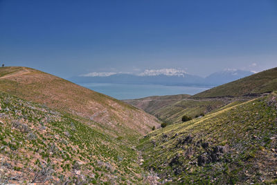 Scenic view of mountains against clear blue sky