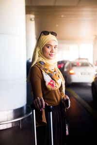 Portrait of woman standing at airport