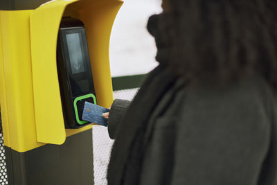 Woman paying for ticket with credit card