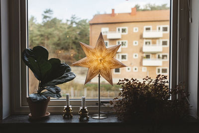 Illuminated star on windowsill