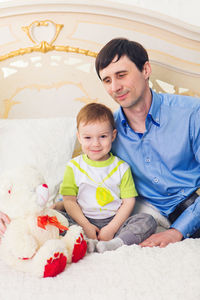 Portrait of a smiling boy sitting at toy