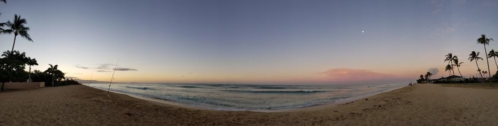 Scenic view of beach against sky during sunset