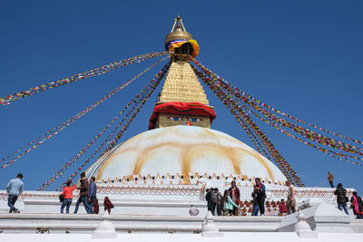 Peope at the boudha stupa, one of the largest stupas in the world in the city of kathmandu in nepal