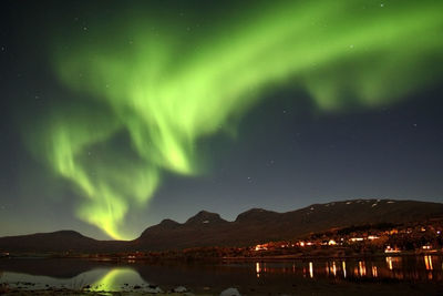 Scenic view of illuminated mountains against sky at night
