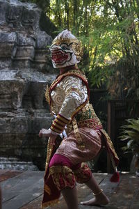 Side view of woman wearing costume dancing outdoors